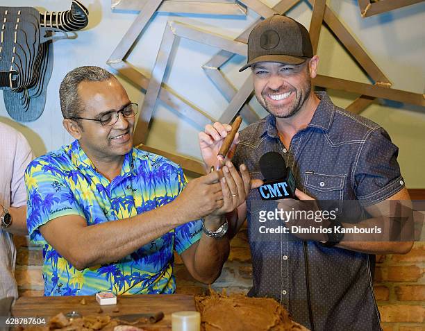 Orlando Jimenez and host Cody Alan participate in Rum Tasting and Cigar Rolling Event during CMT Story Behind The Songs LIV + Weekend Day 2 at...