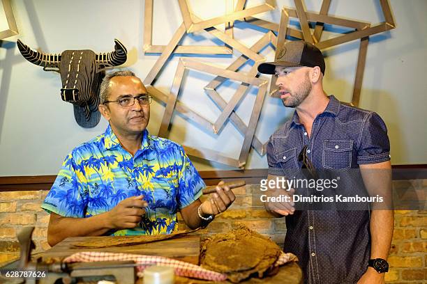 Orlando Jimenez and host Cody Alan participate in Rum Tasting and Cigar Rolling Event during CMT Story Behind The Songs LIV + Weekend Day 2 at...