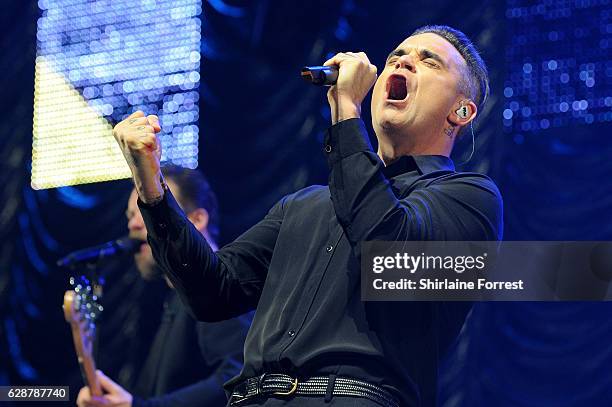 Robbie Williams performs on stage at Key 103 Christmas Live at Manchester Arena on December 9, 2016 in Manchester, England.