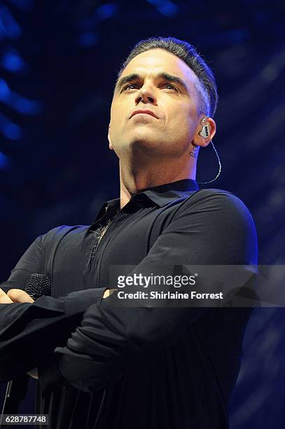 Robbie Williams performs on stage at Key 103 Christmas Live at Manchester Arena on December 9, 2016 in Manchester, England.