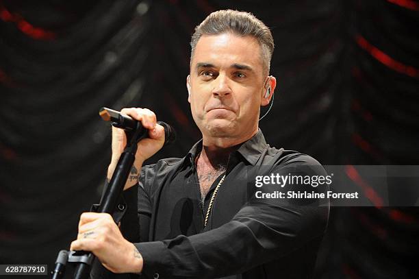 Robbie Williams performs on stage at Key 103 Christmas Live at Manchester Arena on December 9, 2016 in Manchester, England.