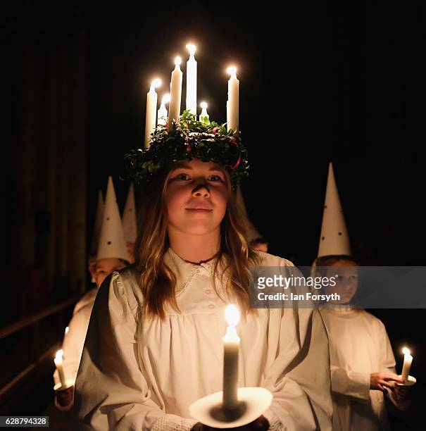 Matilda Jarl from the Jarfalla chamber choir near Stockholm, Sweden plays the role of Lucia as she leads the procession during the Swedish Sankta...