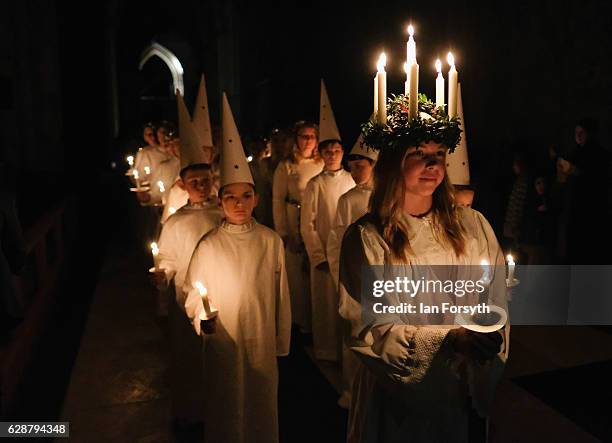 Matilda Jarl from the Jarfalla chamber choir near Stockholm, Sweden plays the role of Lucia as she leads the procession during the Swedish Sankta...