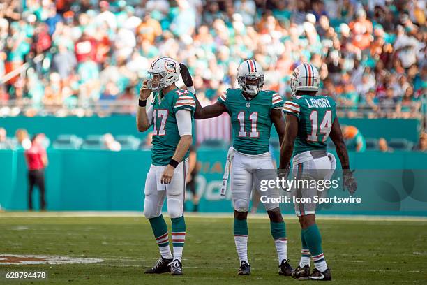 Miami Dolphins quarterback Ryan Tannehill , Miami Dolphins wide receiver DeVante Parker and Miami Dolphins wide receiver Jarvis Landry chat during a...