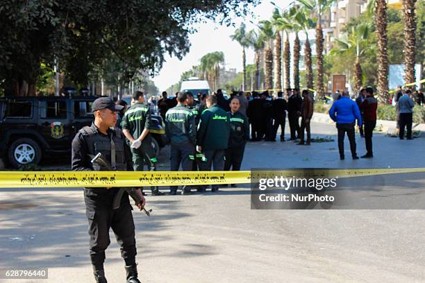 Egyptian security officials inspect the site of a bomb blast, in Giza, Egypt, 09 December 2016. At least six police officers were killed and three...