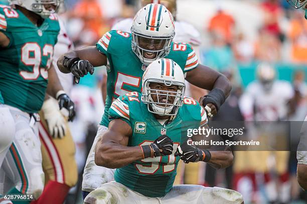 Miami Dolphins defensive end Cameron Wake celebrates with Miami Dolphins outside linebacker Jelani Jenkins after sacking San Francisco 49ers...