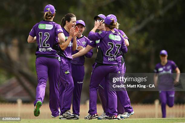 Katelyn Fryett of the Hurricanes celebrates with team mates after taking the wicket of Suzie Bates of the Scorchers during the Women's Big Bash...