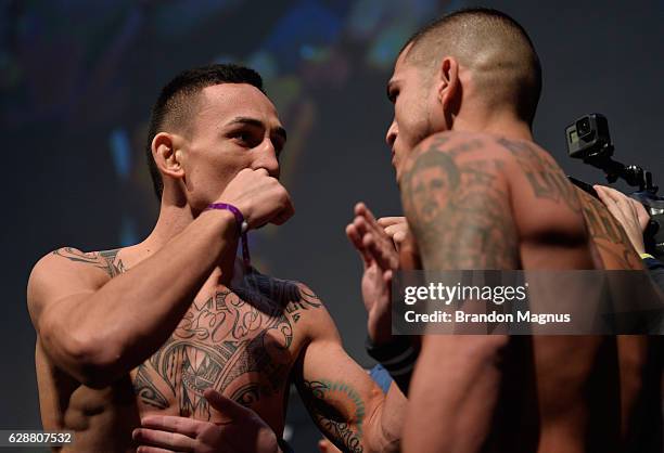 Opponents Max Holloway and Anthony Pettis face off during the UFC weigh-in at Air Canada Centre on December 9, 2016 in Toronto, Ontario, Canada.