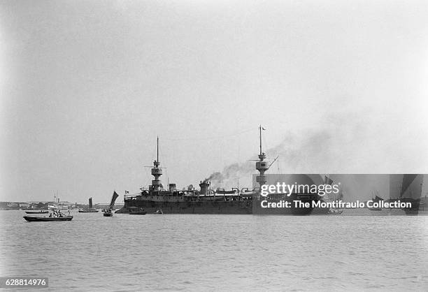 The French Navy armored cruiser Amiral Charner built by Arsenal de Rochefo anchored off a busy Shanghai harbour in China during the Boxer Rebellion...