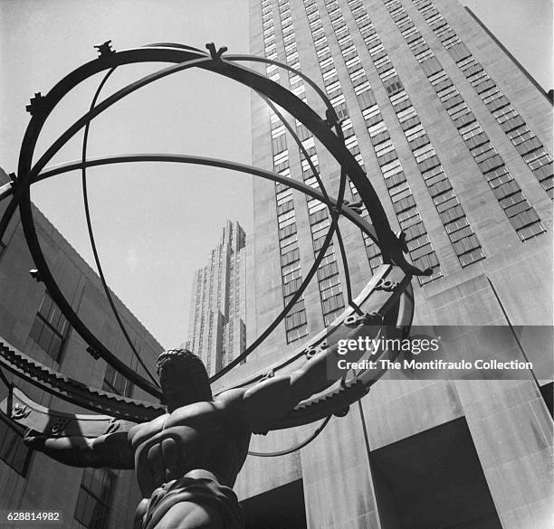 Created by sculptor Lee Lawrie with the help or Rene Paul Chambellan, the bronxe statue of the Greek Titan Atlas holding the Heaves, looms up in...