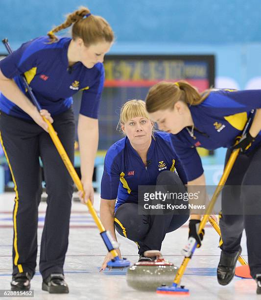 Russia - Vice skip Maria Prytz of Sweden releases the stone in the third end of the women's curling gold medal match against Canada at the Ice Cube...