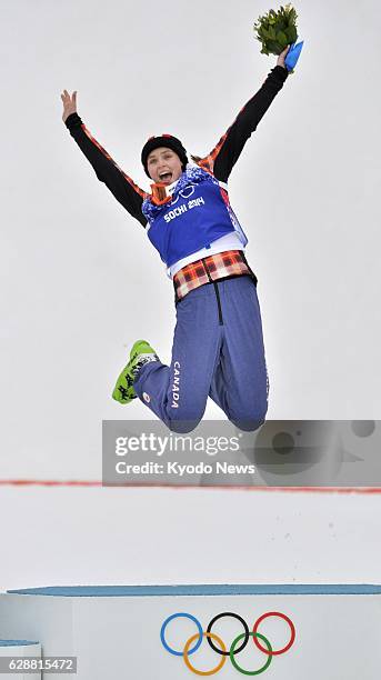 Russia - Canada's Marielle Thompson jumps in joy at the podium after winning gold in the women's freestyle skiing cross of the Winter Olympics in...