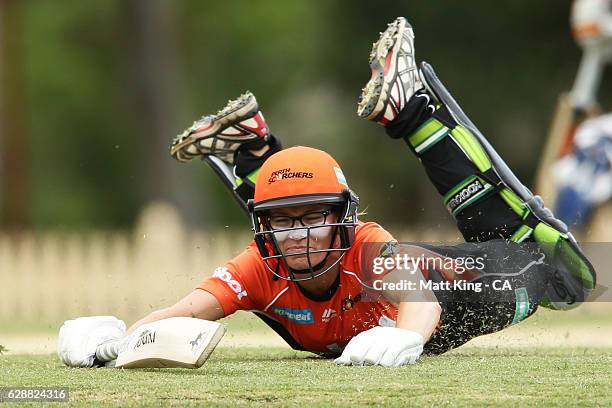 Lauren Ebsary of the Scorchers slides in to avoid a runout during the Women's Big Bash League match between the Hobart Hurricanes and the Perth...