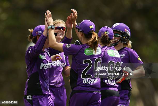 Heather Knight of the Hurricanes celebrates with team mates after taking the wicket of Nicole Bolton of the Scorchers during the Women's Big Bash...