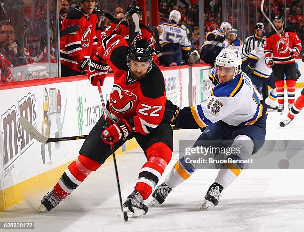 Kyle Quincey of the New Jersey Devils attempts to carry the puck around Robby Fabbri of the St. Louis Blues during the first period at the Prudential...