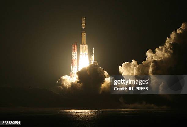 In this photo taken on December 9 Japan's H-IIB rocket launches from the Tanegashima Space Center in Tanegashima island, Kagoshima prefecture. The...