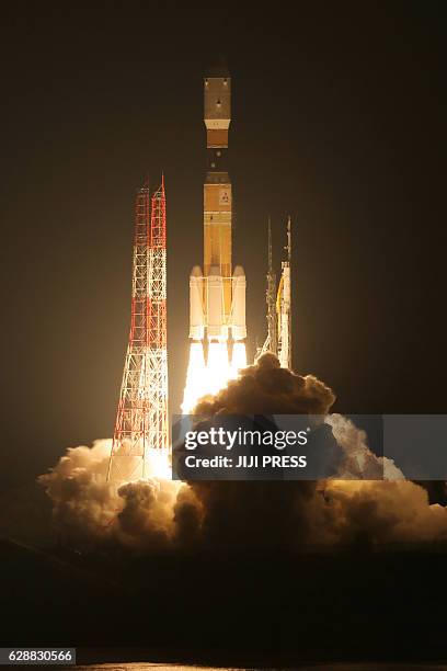 In this photo taken on December 9 Japan's H-IIB rocket launches from the Tanegashima Space Center in Tanegashima island, Kagoshima prefecture. The...