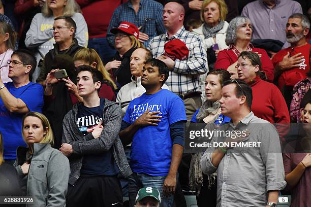 Supporters of Democratic Presidential candidate Hillary Clinton recite the Pledge of Allegiance before US President-elect Donald Trump speaks during...