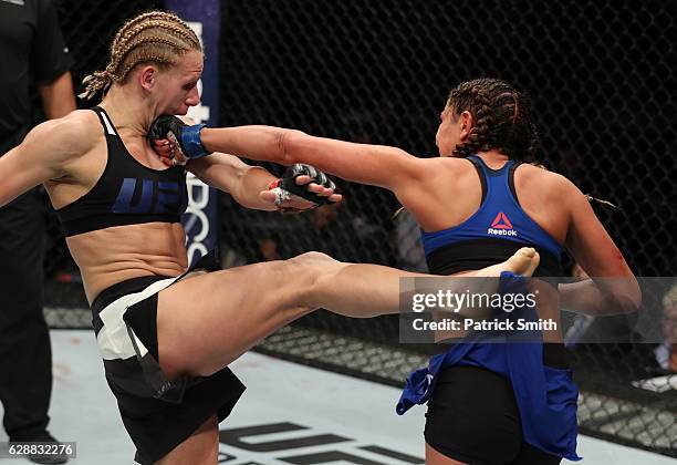 Ashley Yoder punches Justine Kish of Russia in their womens strawweight bout during the UFC Fight Night event at the Times Union Center on December...