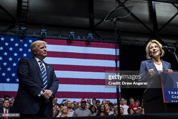 President-elect Donald Trump looks on as Betsy DeVos, his nominee for Secretary of Education, speaks at the DeltaPlex Arena, December 9, 2016 in...