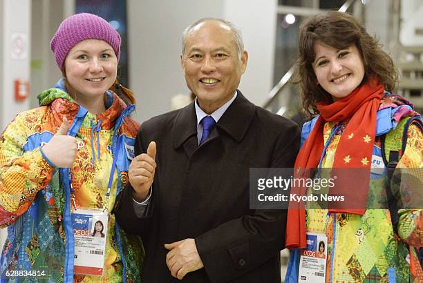 Russia - Tokyo Governor Yoichi Masuzoe and volunteers pose while watching a speed skating event at the Adler Arena Skating Center during the Winter...