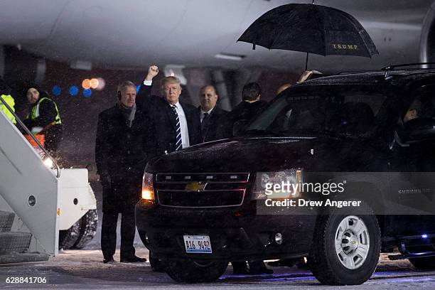 President-elect Donald Trump waves before boarding his plane at Gerald Ford International Airport, December 9, 2016 in Grand Rapids, Michigan....