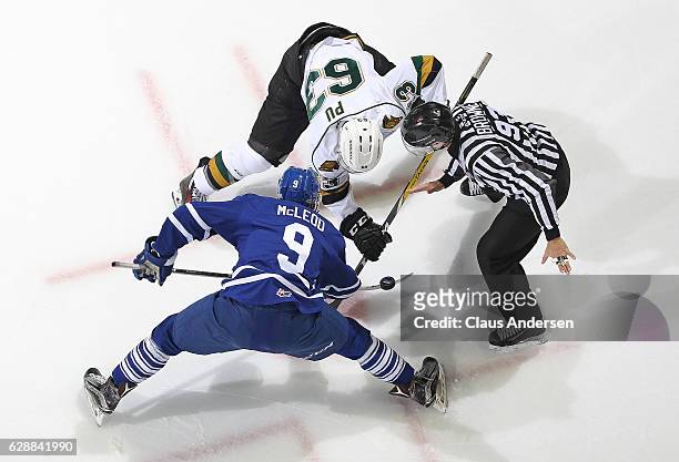Michael McLeod of the Mississauga Steelheads takes a faceoff against Cliff Pu of the London Knights during an OHL game at Budweiser Gardens on...