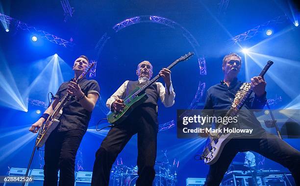 Freddie Edwards,Francis Rossi,John "Rhino" Edwards of Status Quo performing on stage at BIC on December 9, 2016 in Bournemouth, England.