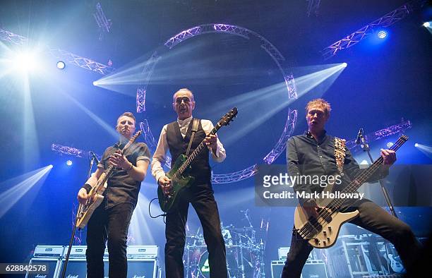 Freddie Edwards,Francis Rossi,John "Rhino" Edwards of Status Quo performing on stage at BIC on December 9, 2016 in Bournemouth, England.