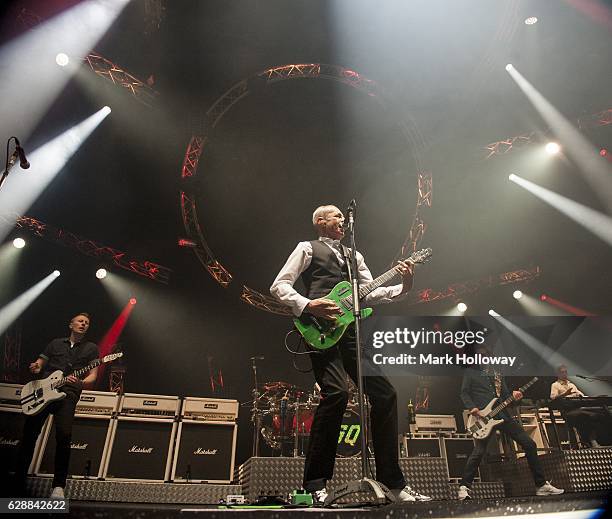 Freddie Edwards,Francis Rossi,John "Rhino" Edwards of Status Quo performing on stage at BIC on December 9, 2016 in Bournemouth, England.