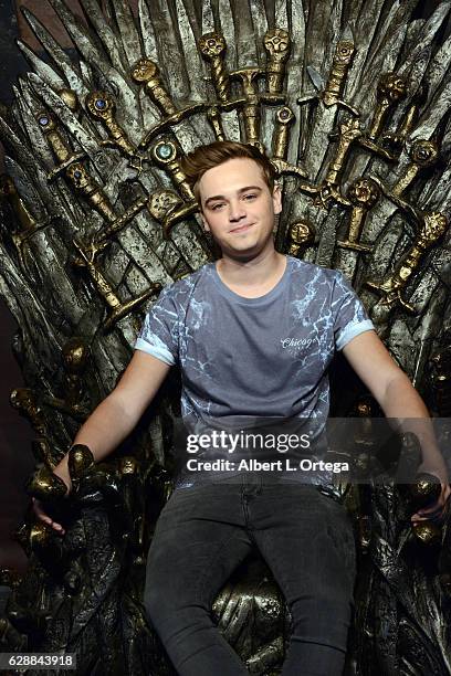 Actor Dean-Charles Chapman sits atop the Iron Throne of Westros at HBO's "Game Of Thrones" Season 6 - Behind The Scenes Fan Event held at Hollywood &...