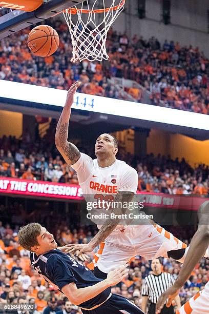 Collin Stewart of the Monmouth Hawks is brought down by a shooting DaJuan Coleman of the Syracuse Orange on November 18, 2016 at The Carrier Dome in...