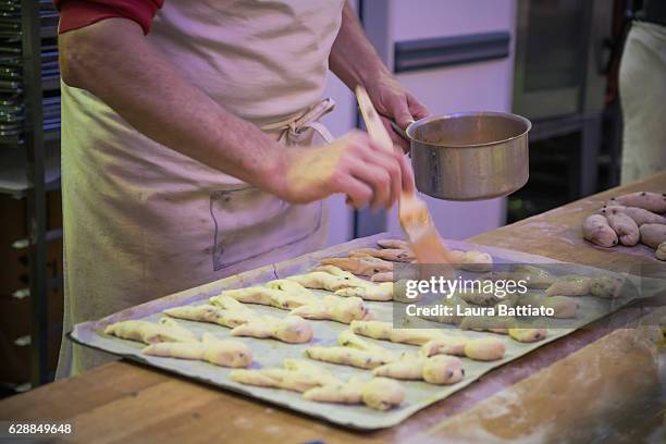 christmas shopping - a baker preparing typical alsatian christmas brioches known as manneles - baker smelling bread stock pictures, royalty-free photos & images