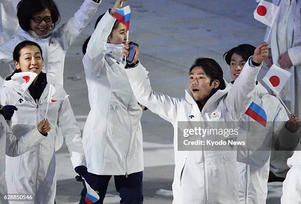 Russia - Japanese figure skaters Mao Asada , Daisuke Takahashi and Tatsuki Machida march during the closing ceremony for the Winter Olympics at Fisht...