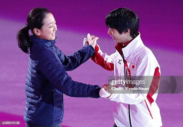 Russia - Japan's Mao Asada and Yuzuru Hanyu hold hands during rehearsal for a Winter Olympics figure skating gala exhibition at the Iceberg Skating...