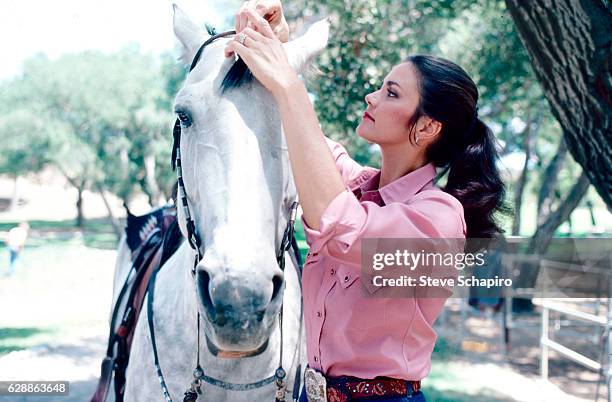 Portrait of American actress Lynda Carter with a horse, Los Angeles, California, 1981.