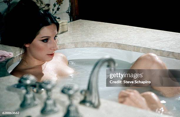 American actress & musician Barbra Streisand sits in a bathtub in a scene from the film 'The Owl and the Pussycat' , 1970.