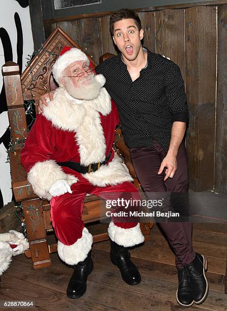 Dean Geyer and Santa at Not For Sale x Z Shoes Benefit at Estrella Sunset on December 9, 2016 in West Hollywood, California.
