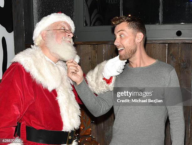 Singer Lance Bass and Santa at Not For Sale x Z Shoes Benefit at Estrella Sunset on December 9, 2016 in West Hollywood, California.