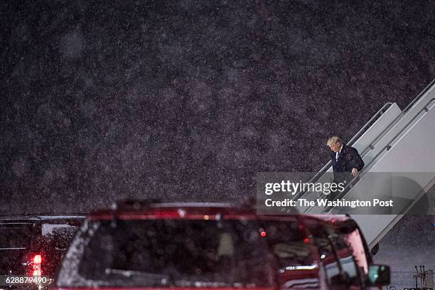 President-Elect Donald J. Trump disembarks his plane in the snow as he makes his way to a "USA Thank You Tour 2016" event at the DeltaPlex in Grand...