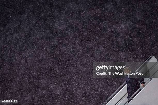 President-Elect Donald J. Trump disembarks his plane in the snow as he makes his way to a "USA Thank You Tour 2016" event at the DeltaPlex in Grand...