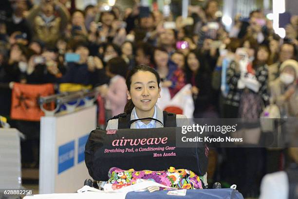 Japan - Mao Asada arrives at Narita airport near Tokyo on Feb. 25 as the Japanese figure skating squad returned from the Winter Olympics in Sochi,...