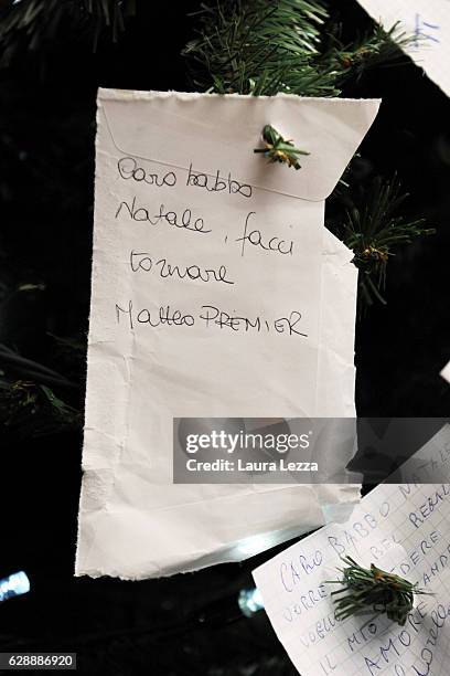Christmas note that reads ' Caro Babbo Natale facci tornare Matteo Premier' is displayed on a Christmas tree at Santa Maria Novella train station on...