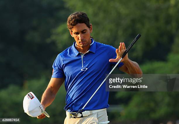 Rafa Cabrera Bello of Spain tosses up his putter on the 18th green during the third round of the UBS Hong Kong Open at The Hong Kong Golf Club on...