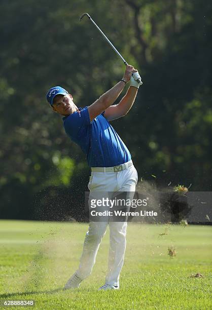 Danny Willett of England plays his second shot into the 11th green during the third round of the UBS Hong Kong Open at The Hong Kong Golf Club on...