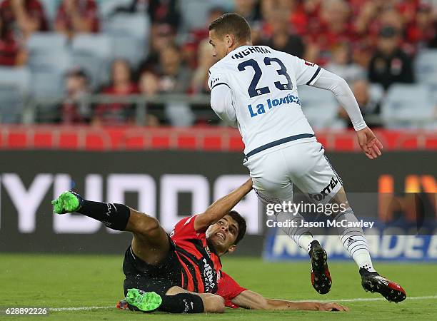 Jai Ingham of the Victory is challenged by Jonathan Aspropotamitis of the Wanderers during the round 10 A-League match between the Western Sydney...