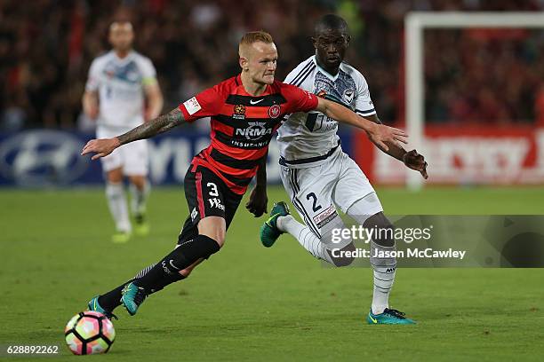 Jack Clisby of the Wanderers is challenged by Jason Geria of the Victory during the round 10 A-League match between the Western Sydney Wanderers and...