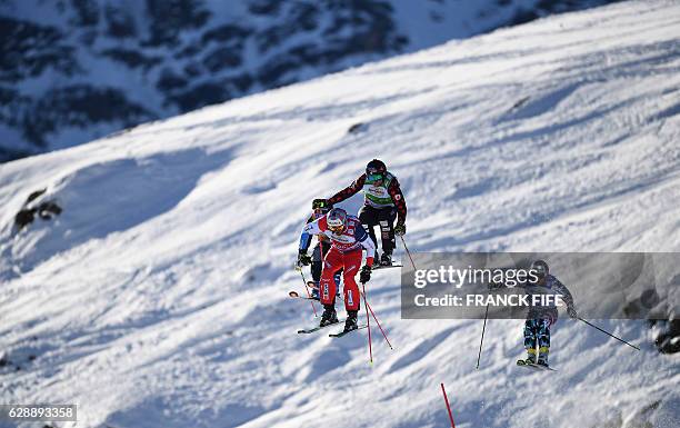 Switzerland's Alex Fiva, Canada's Brady Leman and Austria's Christoph Wahrstotter compete during the FIS Men's-final Skicross World Cup on December...
