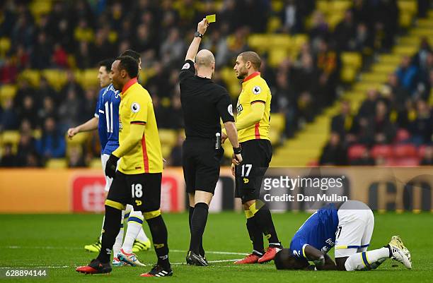 Referee Anthony Taylor shows a yellow card to Adlene Guedioura of Watford during the Premier League match between Watford and Everton at Vicarage...