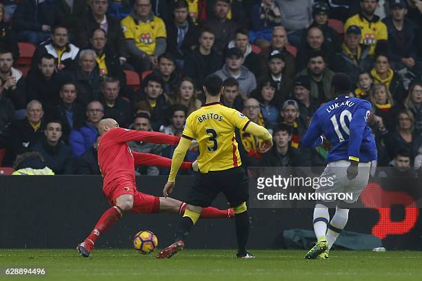 Everton's Belgian striker Romelu Lukaku shoots and scores past Watford's Brazilian goalkeeper Heurelho Gomes during the English Premier League...